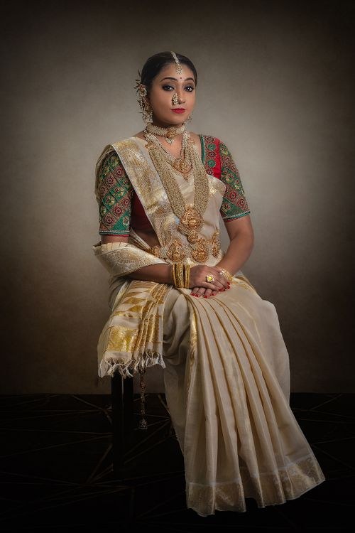 Woman in an ivory silk saree with gold temple jewellery