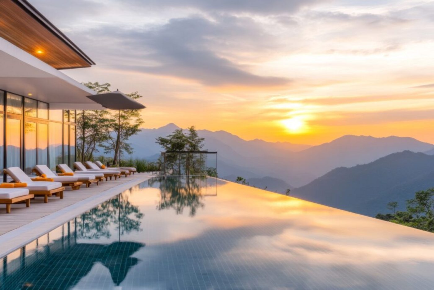 The lodge infinity pool reflecting a golden sunset over the mountain lake