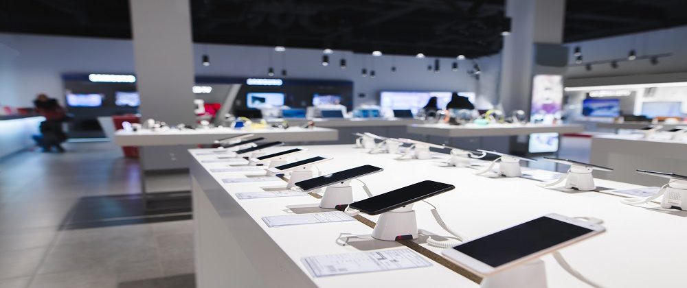 A row of smartphones on display stands in the shop