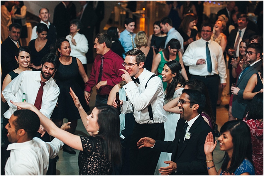 Guests laughing and mingling at an evening celebration
