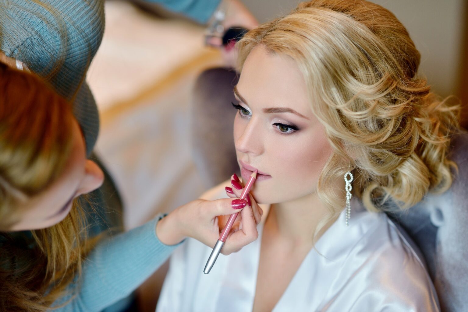 Makeup artist applying bridal makeup