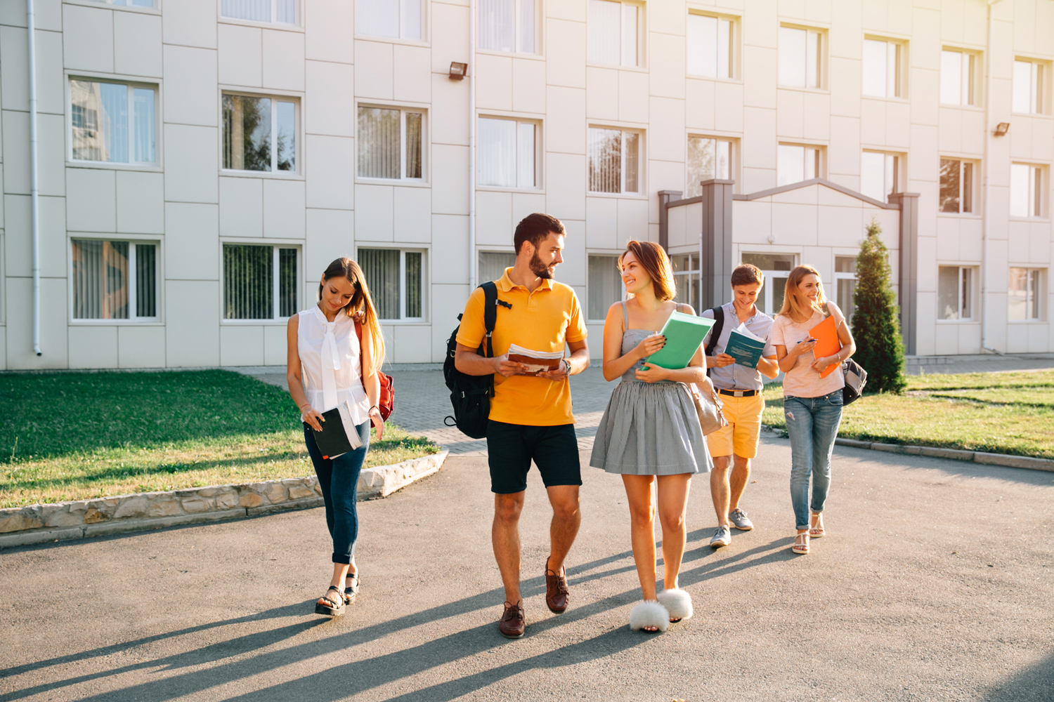 Students walking together across the Horizon Academy campus with their books