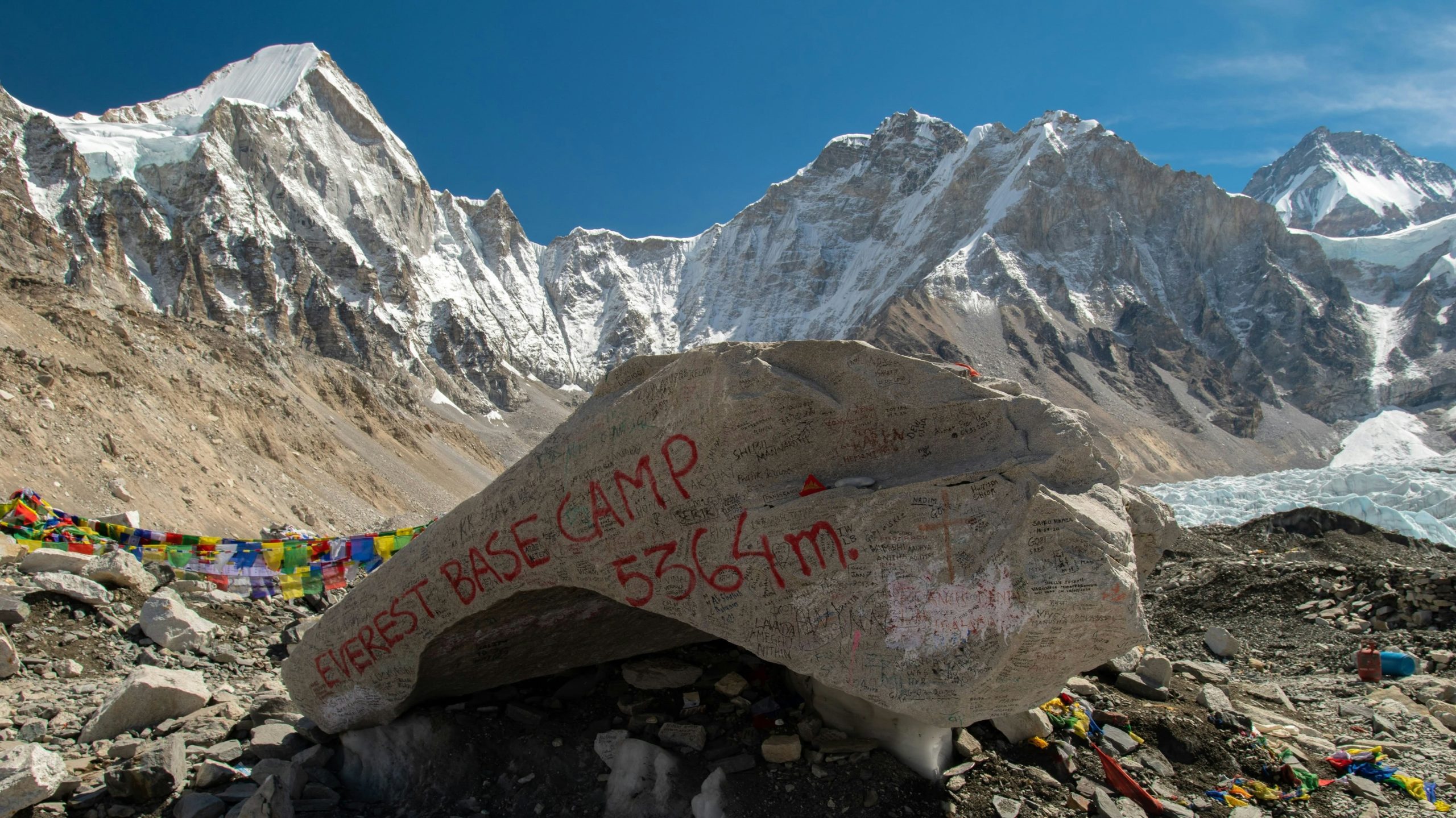 Everest Base Camp marker rock at 5,364 metres with the Khumbu Himalaya behind it